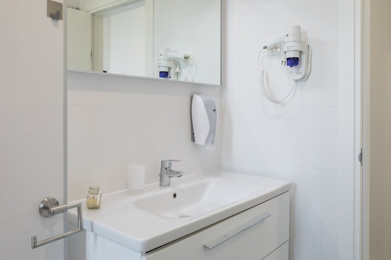 Badezimmer 1: Handwaschbecken, Stauraum, Föhn, Spiegel, Seifenspender