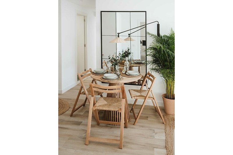 A charming dining space with wooden furniture and a beautiful flowerpot.