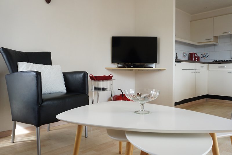 Modernes Wohnzimmer mit komfortablen Möbeln und Flachbildfernseher.