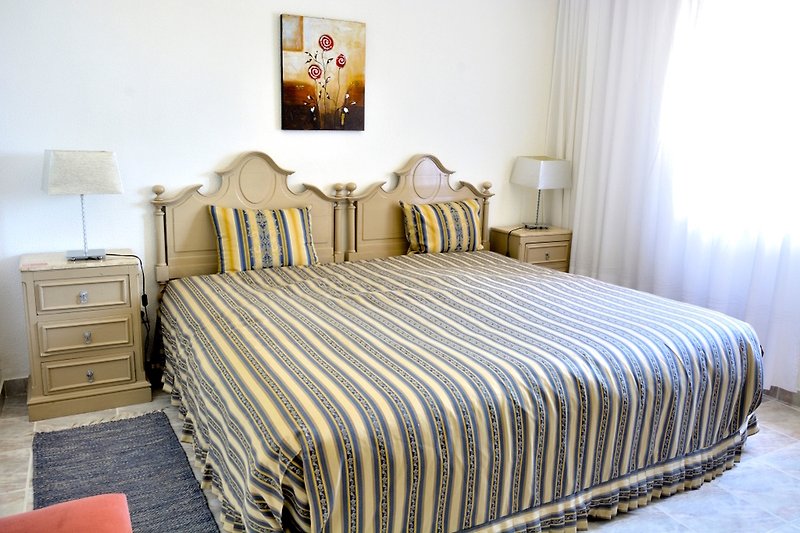 Rent this cozy bedroom with a comfortable bed, stylish curtains, and warm wood accents.