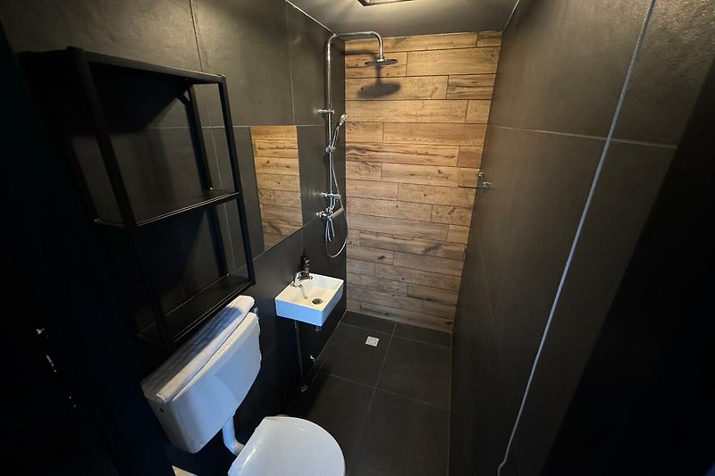 Stylish bathroom with modern fixtures and elegant lighting.