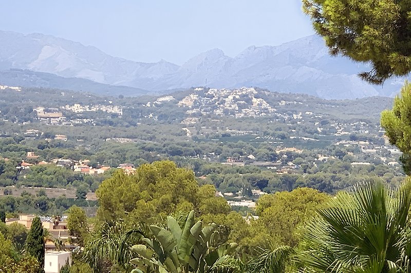 Aussicht von der Überdachung auf das Dorf La Nucia und Polop mit hohen Bergen im Hintergrund