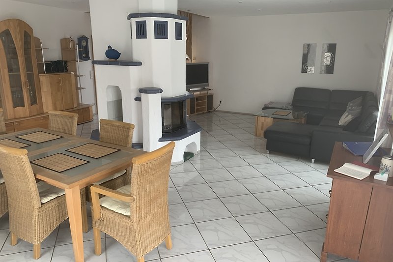 Wohnzimmer mit Holzmöbeln, Couch, Tisch und Fernseher.