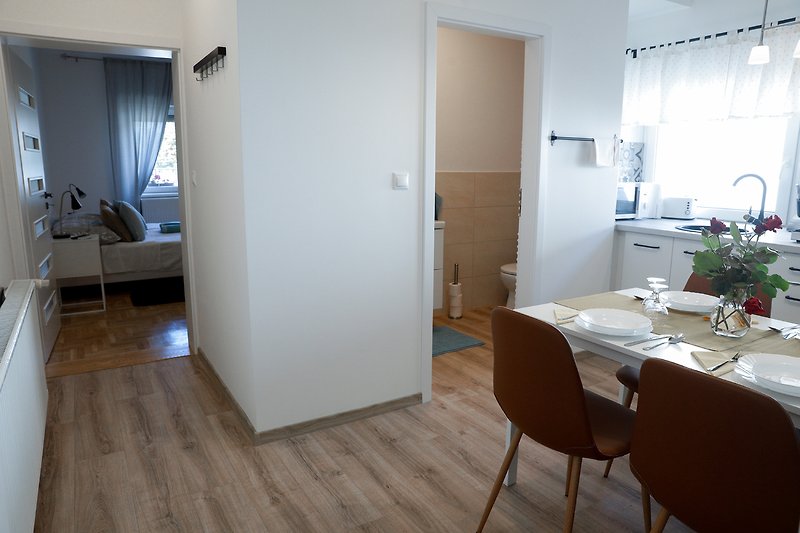 Apartment 3. Stylish interior with wood furniture, elegant fixtures, and natural light.