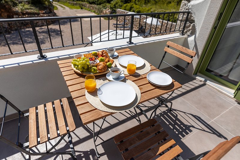 Elegante Terrasse mit stilvoller Tischdekoration und bequemen Stühlen.