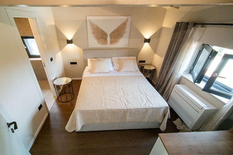 Stylish bedroom with elegant decor and soft lighting.