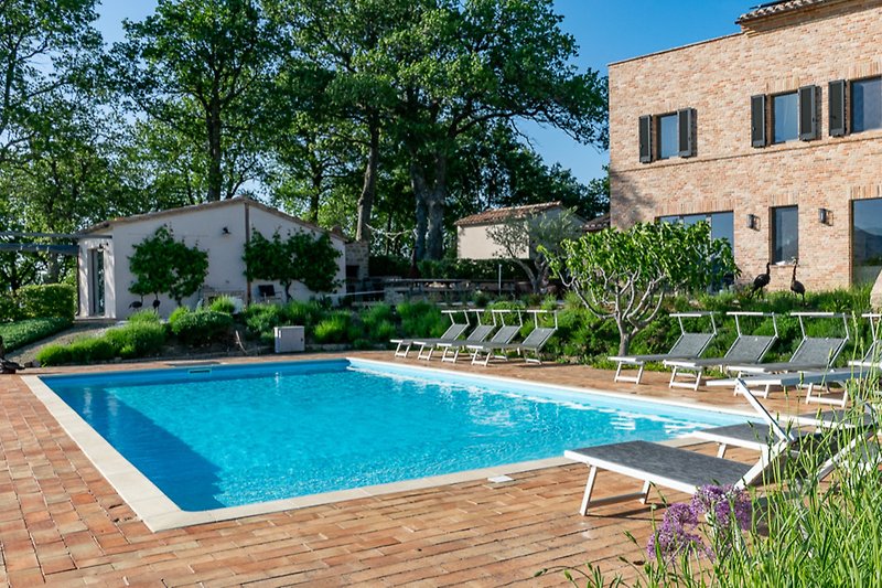Tranquil property with a refreshing swimming pool and lush landscaping.