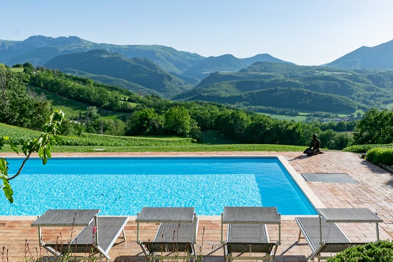 Relax by the pool with a view of the mountains.