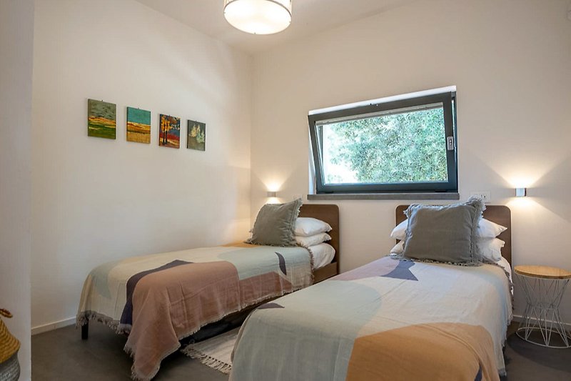 Stylish bedroom with cozy lighting, elegant bedding, and modern decor.