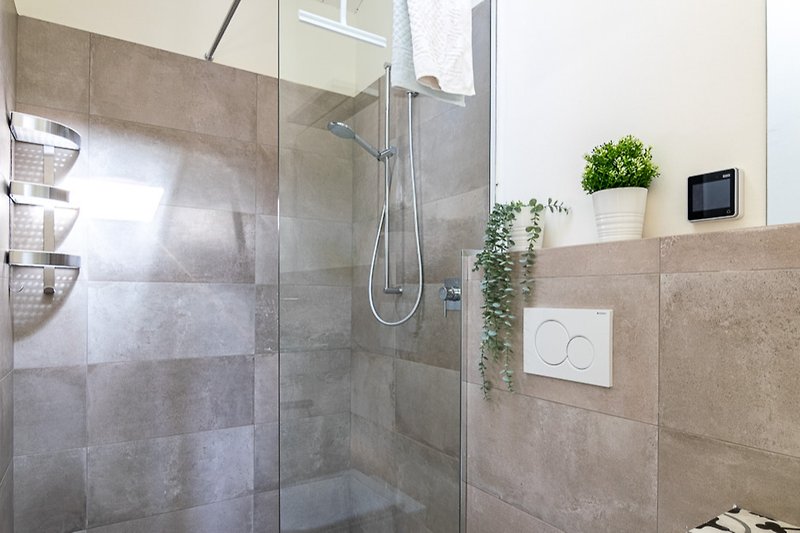 Modern bathroom with elegant fixtures, stylish lighting, and marble walls.