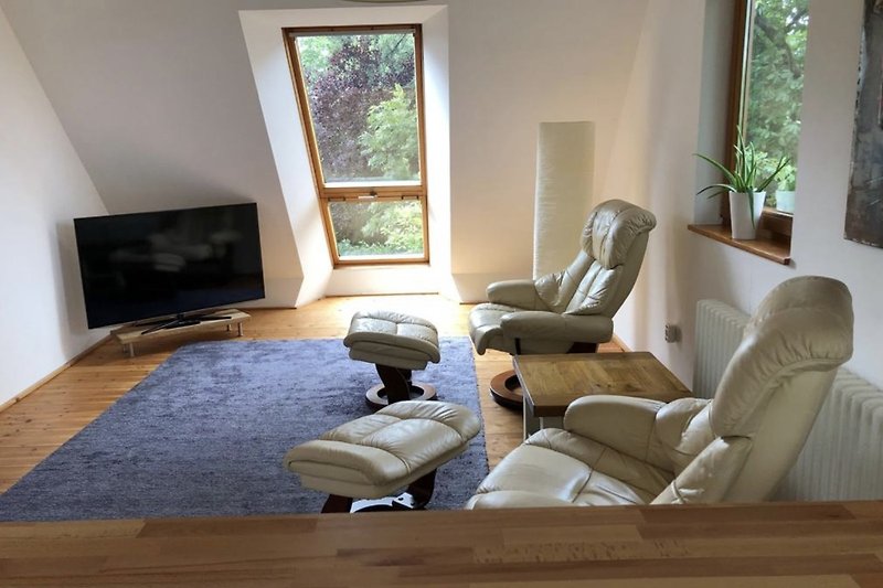 Stilvolles Wohnzimmer mit bequemen Möbeln und Pflanzen.