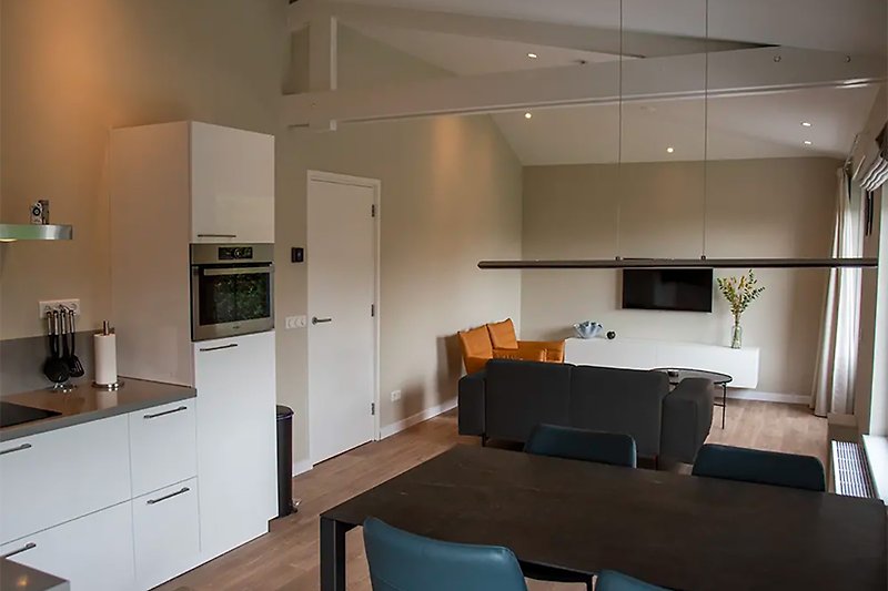 Moderne Küche mit Holzmöbeln, Küchengeräten und Fenster.