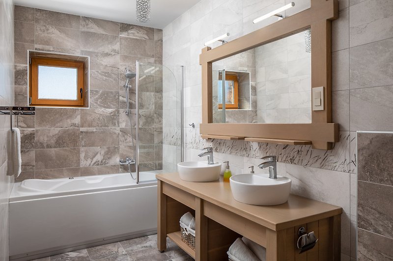 Modernes Badezimmer mit Glaswaschbecken, Spiegel und Badarmatur.