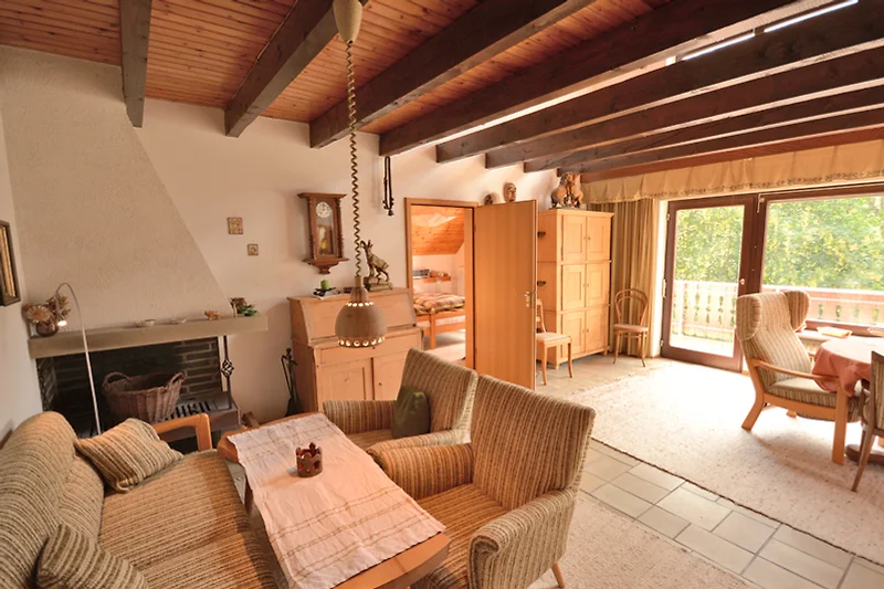 Wohnzimmer mit Holzmöbeln, bequemer Couch und Fenster. Gemütliche Atmosphäre.