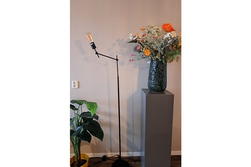 Kunstvolle Blumenarrangements und Pflanzen im stilvollen Raum.