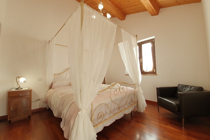 Schlafzimmer mit Holzbett, Lampe und Fenster - stilvoll eingerichtet!