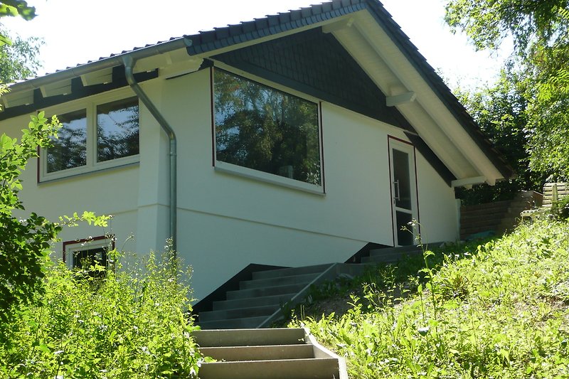 Gemütliches Haus mit Satteldach und Garten im Grünen.