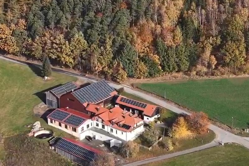 Luftaufnahme eines Anwesens mit Landschaftsgestaltung und Bauernhaus.