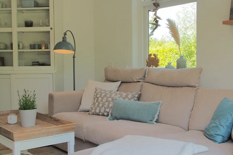 Wohnzimmer mit Ecksofa, Sessel und Couchtisch