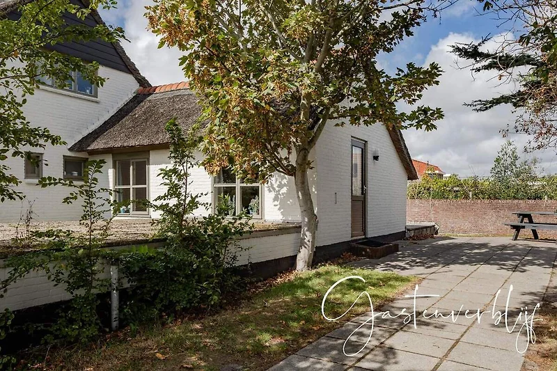 Großzügiges Haus mit gepflegtem Garten, Einfahrt und schöner Fassade.