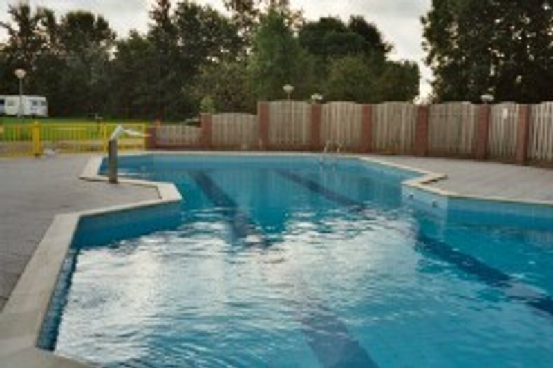 Solar-heated secured pool with separate children's pool.