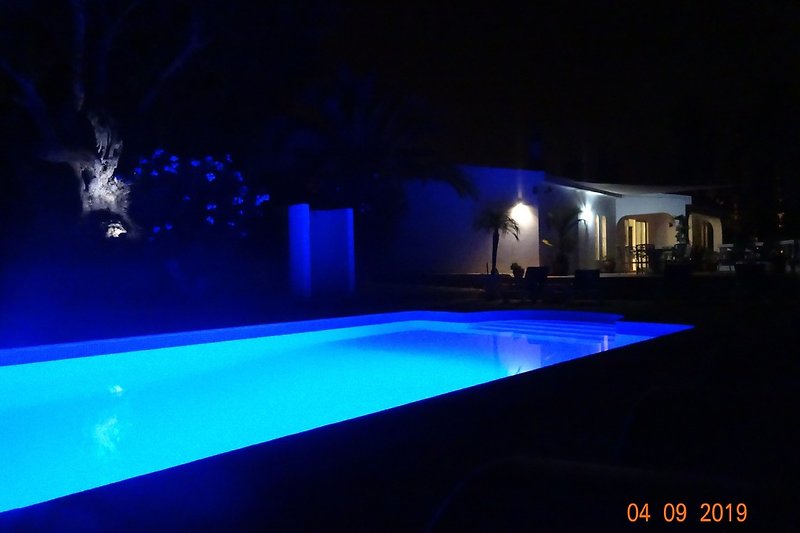 Illuminated swimming pool, spacious terraces