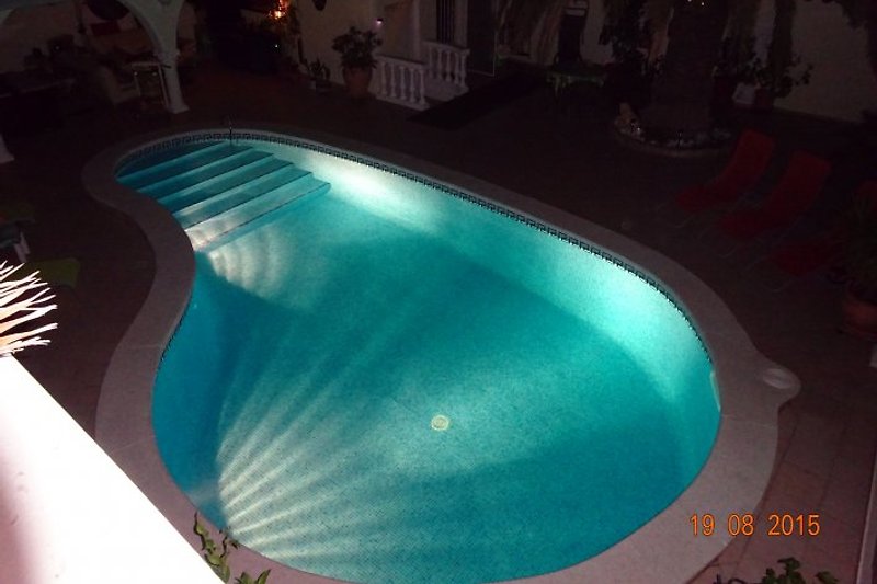 Pool area with nighttime lighting.