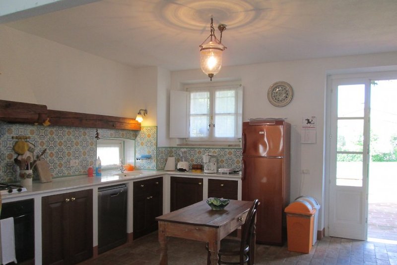The kitchen with dishwasher, refrigerator and freezer. Through the door, you go directly to the terrace.