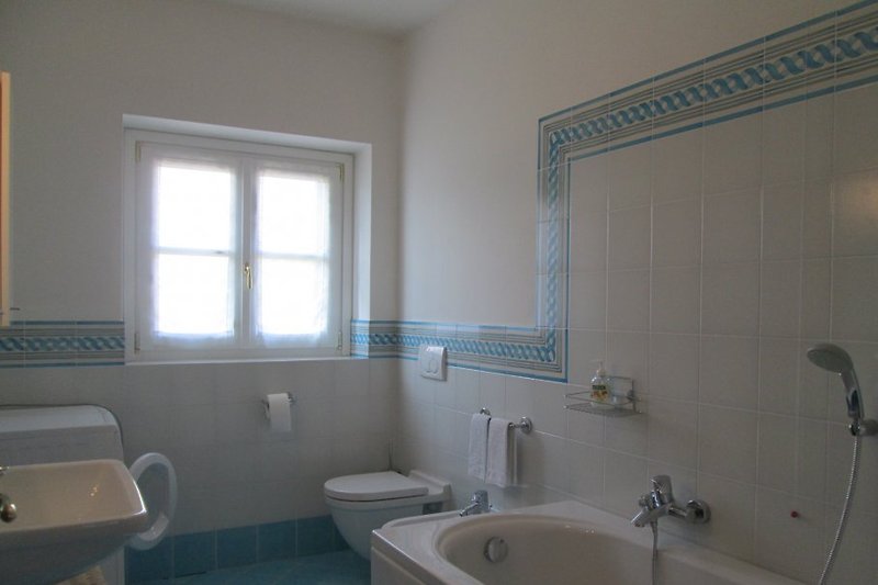 On the 1st floor, the largest of the three bathrooms with a bathtub, bidet, and washing machine.