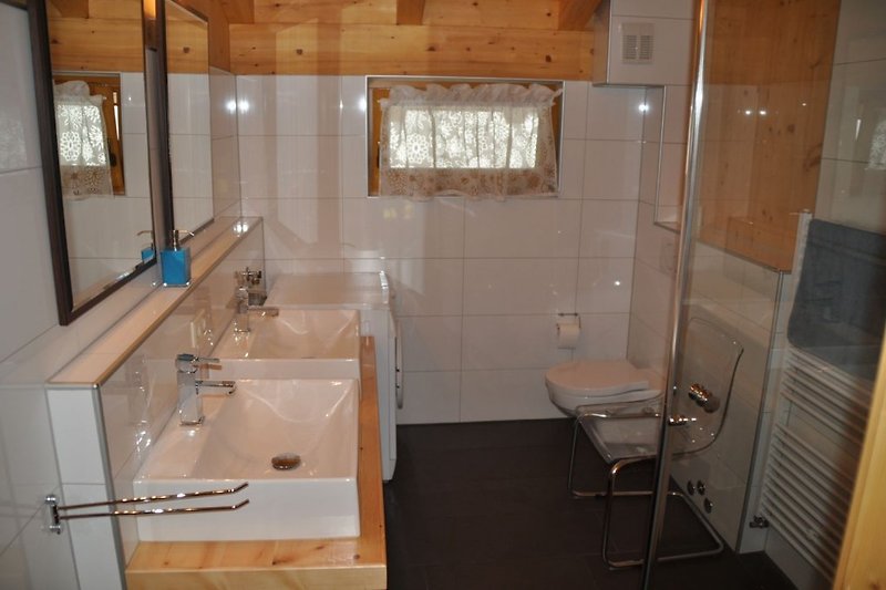 Bathroom with double sink and toilet upper floor