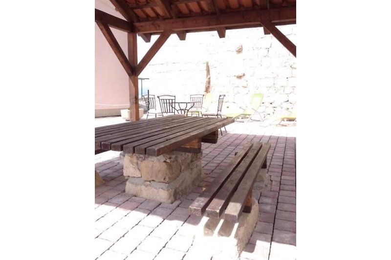 Rustic, covered seating area in the courtyard.