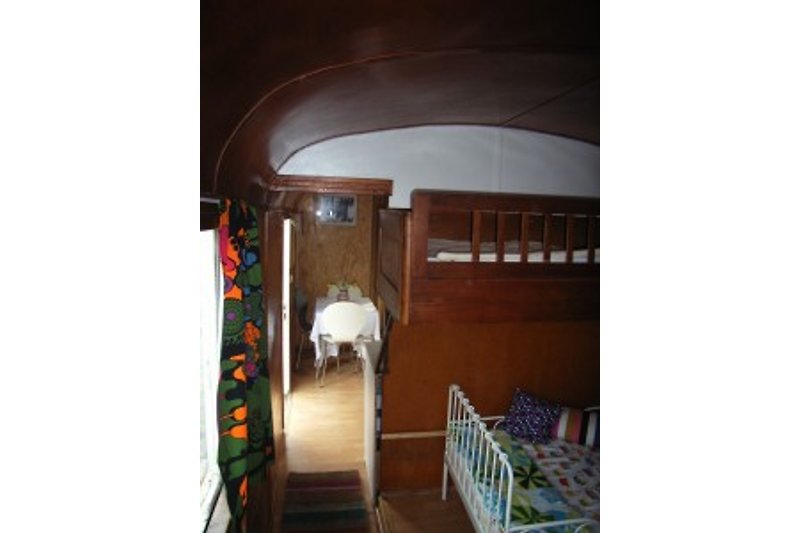 Children's sleeping area with 2 beds and travel cot.