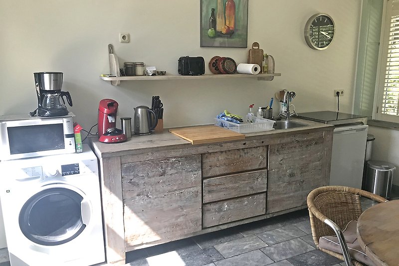 Ein stilvolles Kücheninterieur mit modernen Geräten und Holzmöbeln.