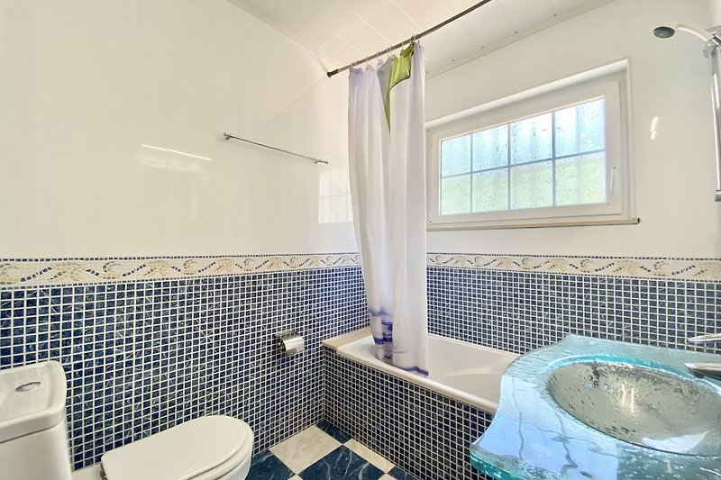 Modernes Badezimmer mit lila Akzenten und Glasdusche.