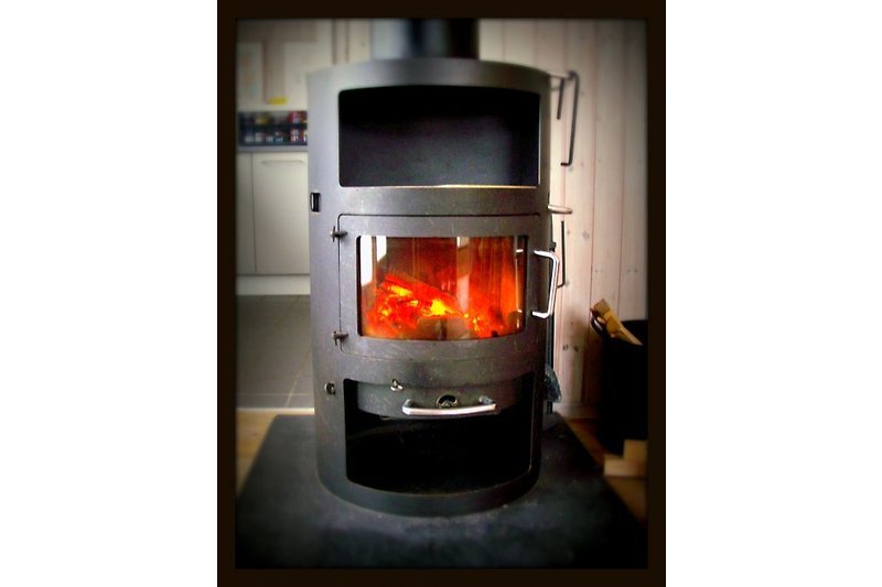 The wood-burning stove contributes to the evening atmosphere.