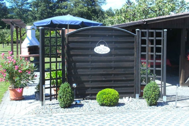 Our covered outdoor seating area with barbecue spot.
