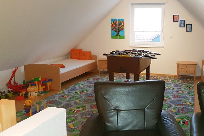 The attic with foosball table and play area.