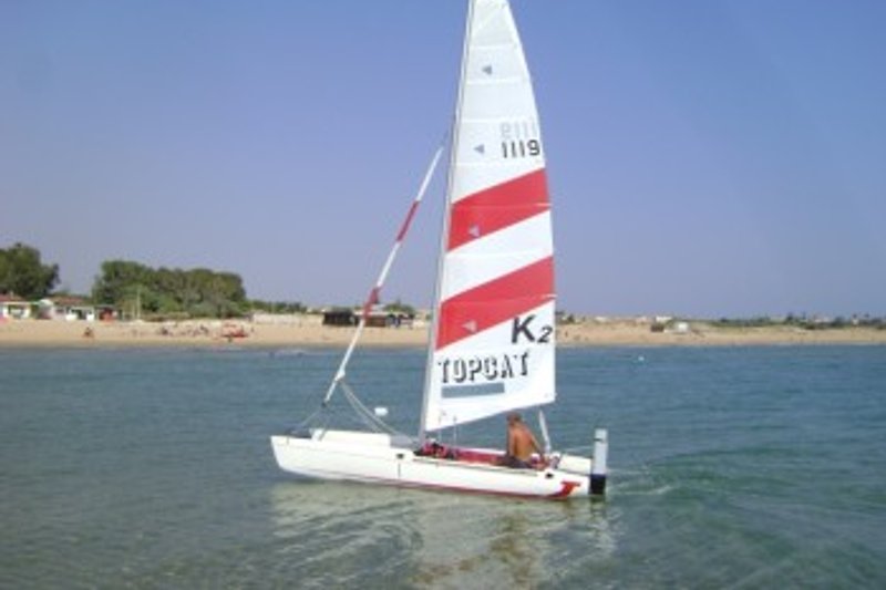 Sailboat with beach view.