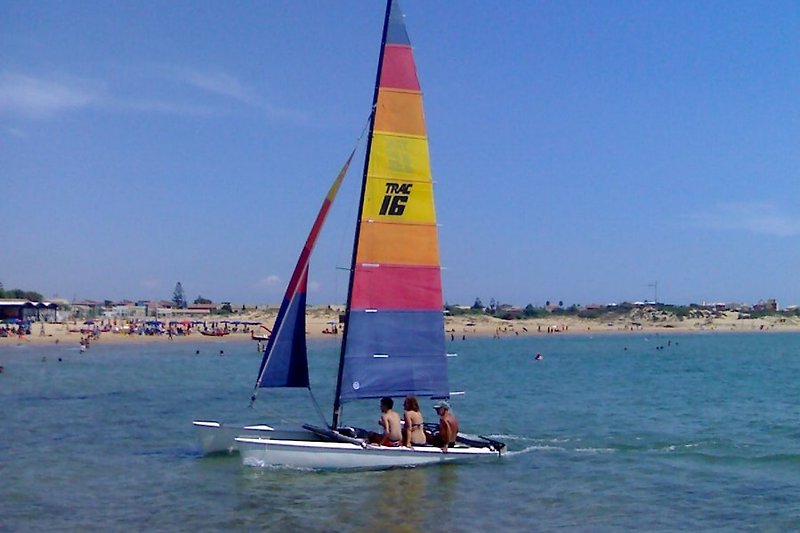Sailboat with beach view from the pier