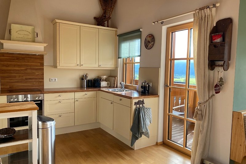 Very fully equipped kitchen and door to balcony.