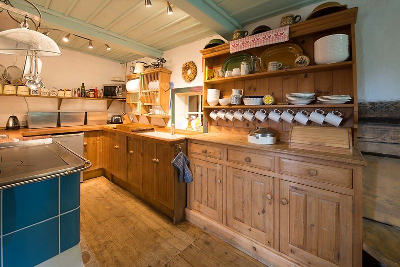 The well equipped kitchen also has a dishwasher, an electric oven, 2 electric hobs and a wood burning Aga stove